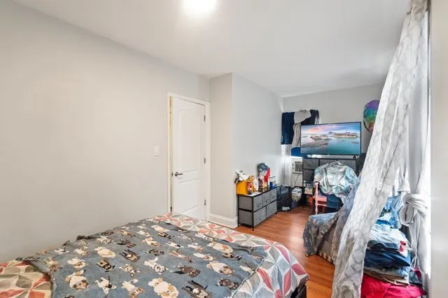 a bedroom with bed and a window