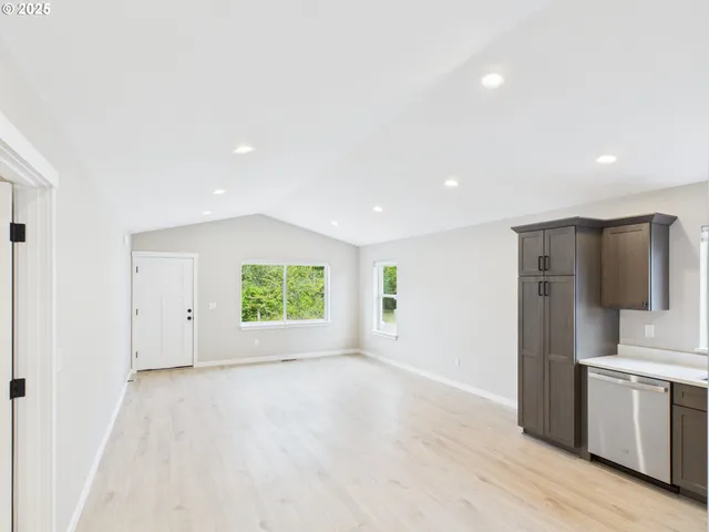 a view of kitchen with stainless steel appliances a refrigerator and a stove top oven