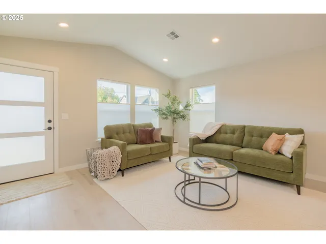 a living room with furniture a air conditioner and a window