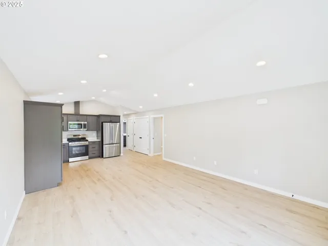 a view of a kitchen with a sink and a refrigerator
