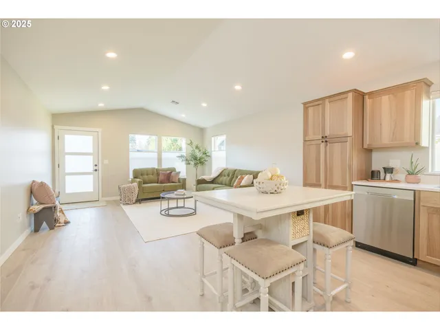 a kitchen with a sink dining table and chairs