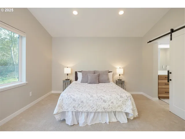 a bedroom with a bed and a night stand