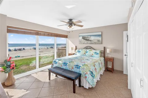 a bedroom with furniture and large windows