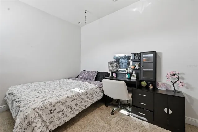 a bedroom with a bed and with furniture