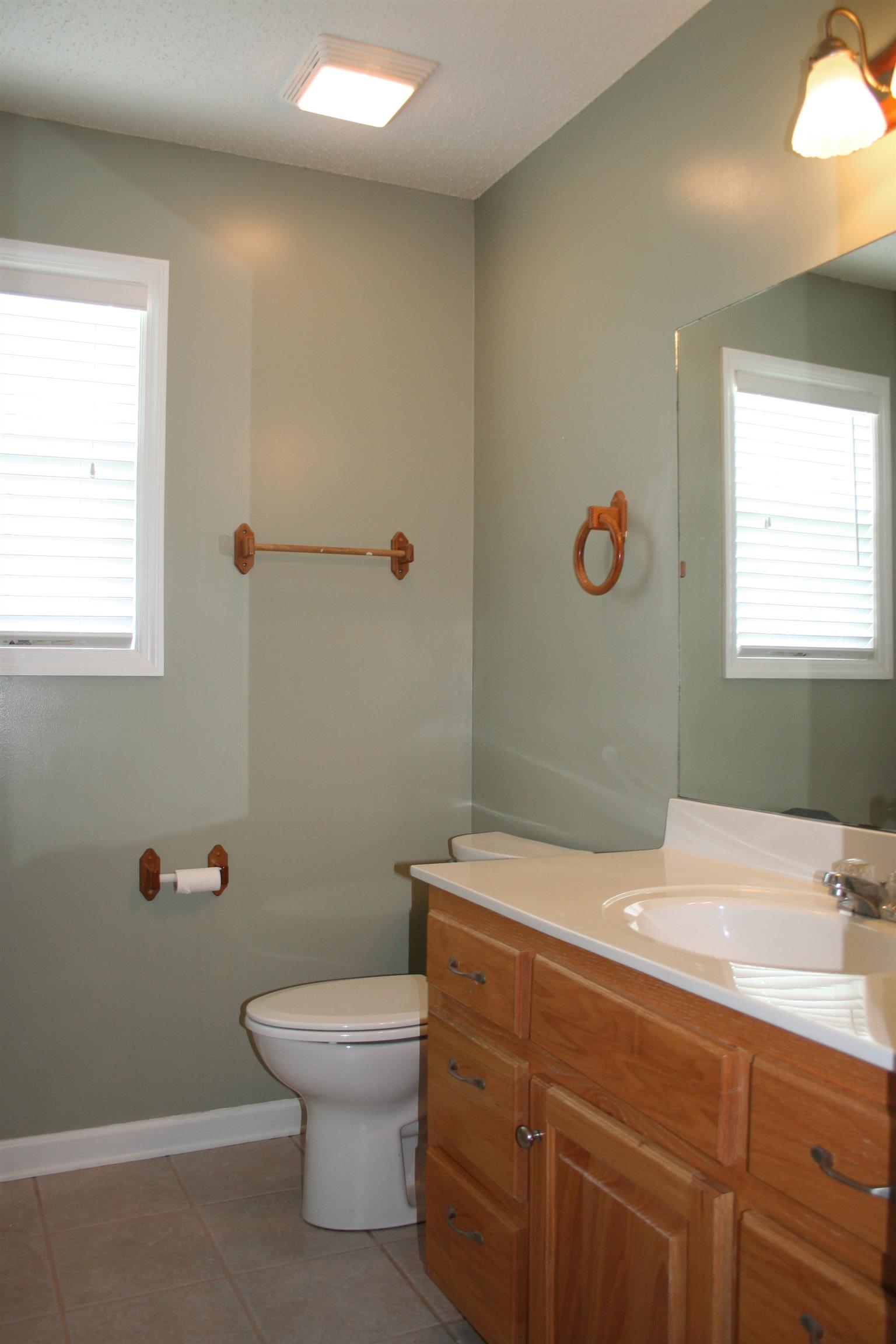 7615 Beech Hill Road Pulaski, TN 38478 - Photo 22 of 30 a bathroom with a granite countertop toilet a sink and a mirror
