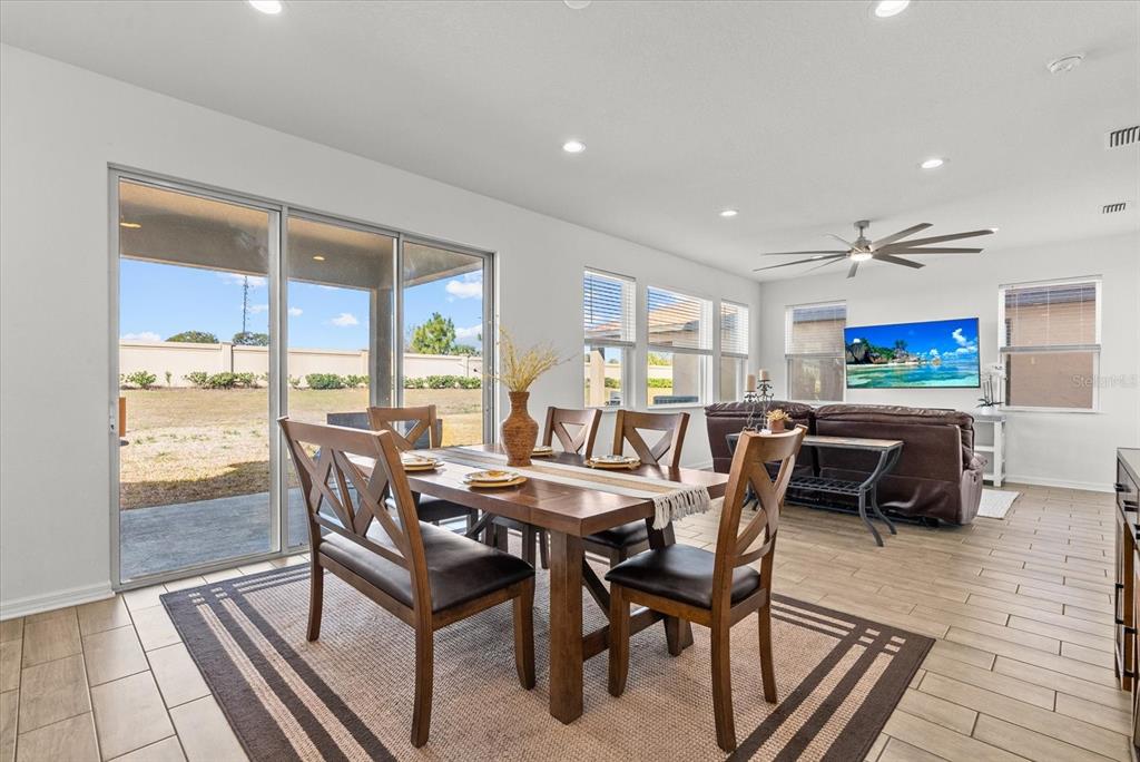 8330 Abalone Loop Palmetto, FL 34221 - Photo 11 of 45 a dining room with furniture and a floor to ceiling window