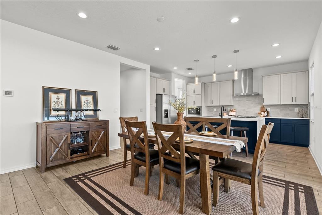 8330 Abalone Loop Palmetto, FL 34221 - Photo 12 of 45 a large kitchen with dining table chairs and granite counter tops