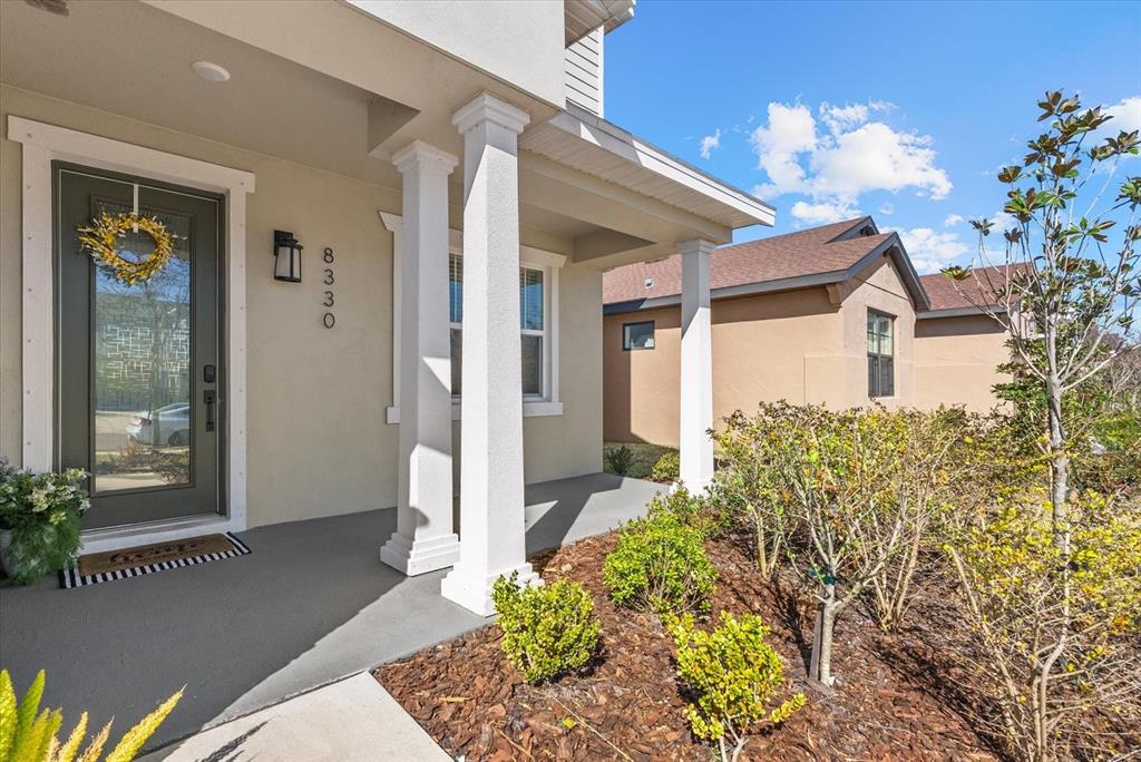 8330 Abalone Loop Palmetto, FL 34221 - Photo 2 of 45 a front view of a house with a garden