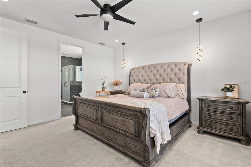 8330 Abalone Loop Palmetto, FL 34221 - Photo 23 of 45 a bedroom with a bed and a dresser