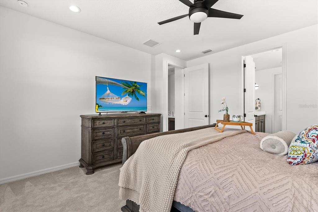 8330 Abalone Loop Palmetto, FL 34221 - Photo 25 of 45 a bedroom with a bed and a flat screen tv