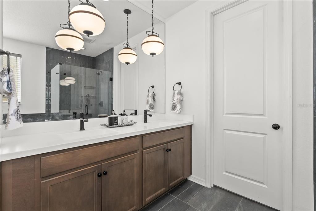 8330 Abalone Loop Palmetto, FL 34221 - Photo 26 of 45 a bathroom with a double vanity sink and a mirror