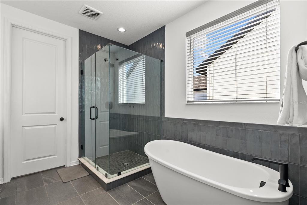 8330 Abalone Loop Palmetto, FL 34221 - Photo 27 of 45 a bathroom with a tub a toilet and a shower