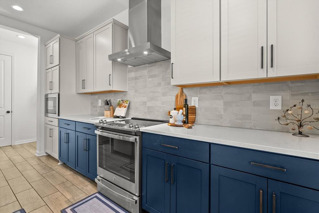 8330 Abalone Loop Palmetto, FL 34221 - Photo 8 of 45 a kitchen with stainless steel appliances granite countertop a sink a stove and a refrigerator