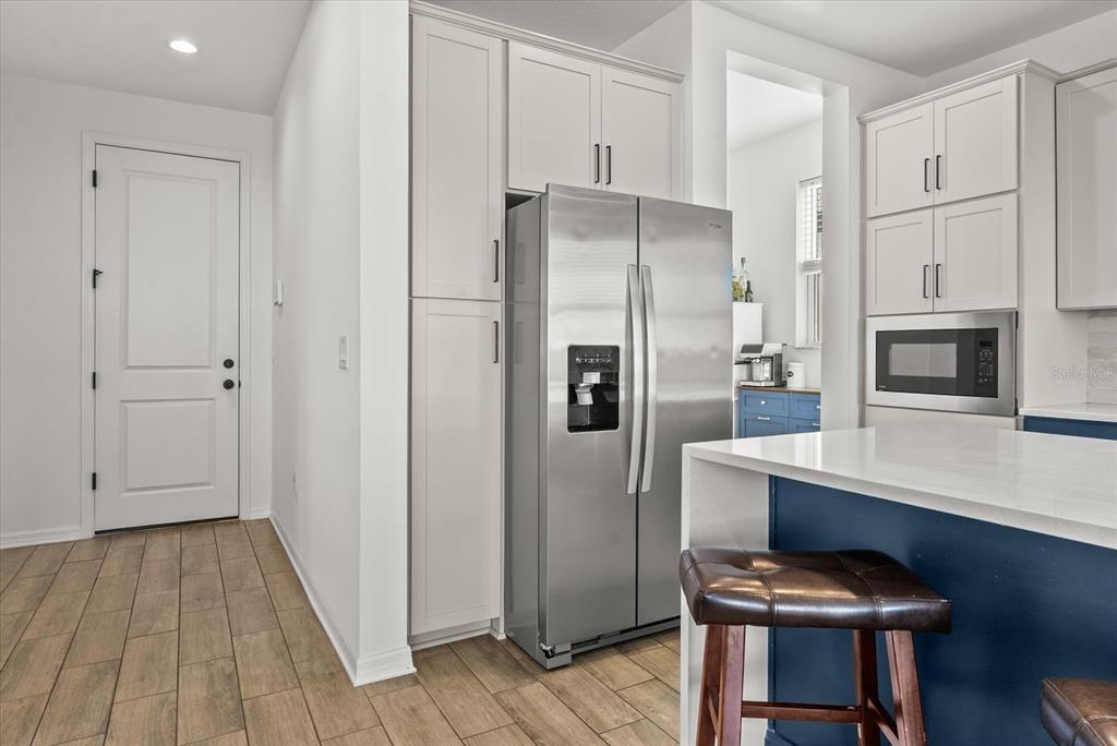 8330 Abalone Loop Palmetto, FL 34221 - Photo 9 of 45 a kitchen with stainless steel appliances a refrigerator and a stove top oven