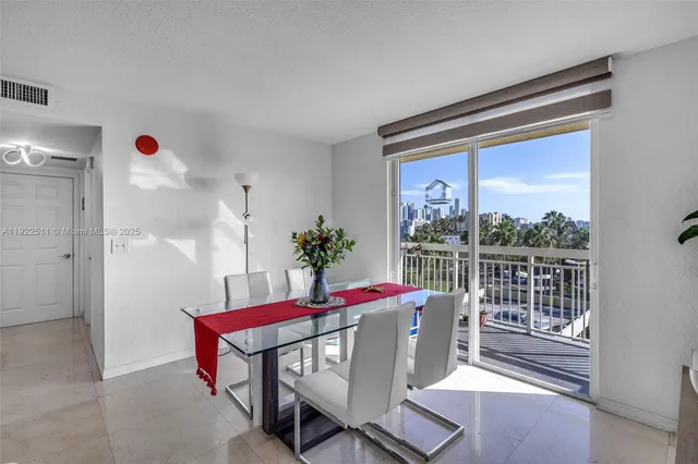 a dining room with furniture window and outdoor view