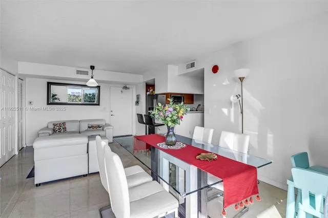 a living room with furniture a rug and white walls