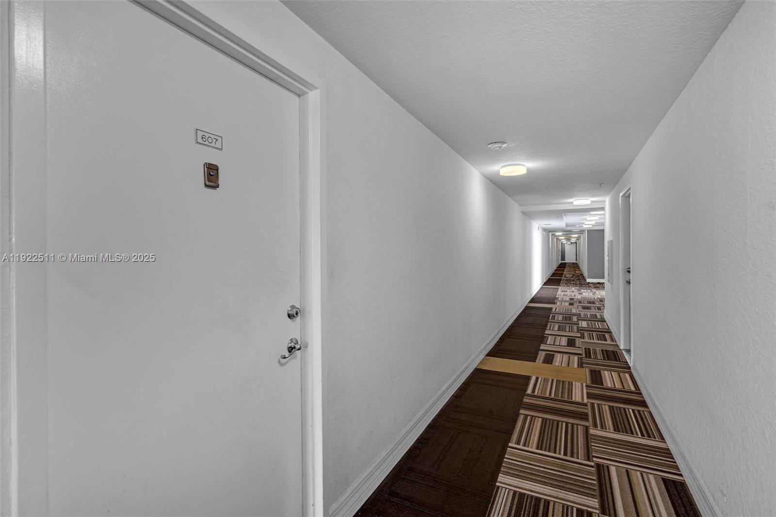 816 Northwest 11th Street, Unit 607 Miami, FL 33136 - Photo 18 of 38 a view of a hallway with wooden floor and staircase