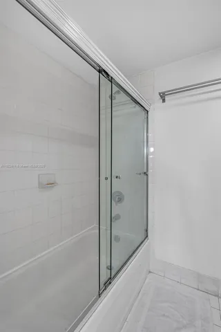 a bathroom with a glass shower door