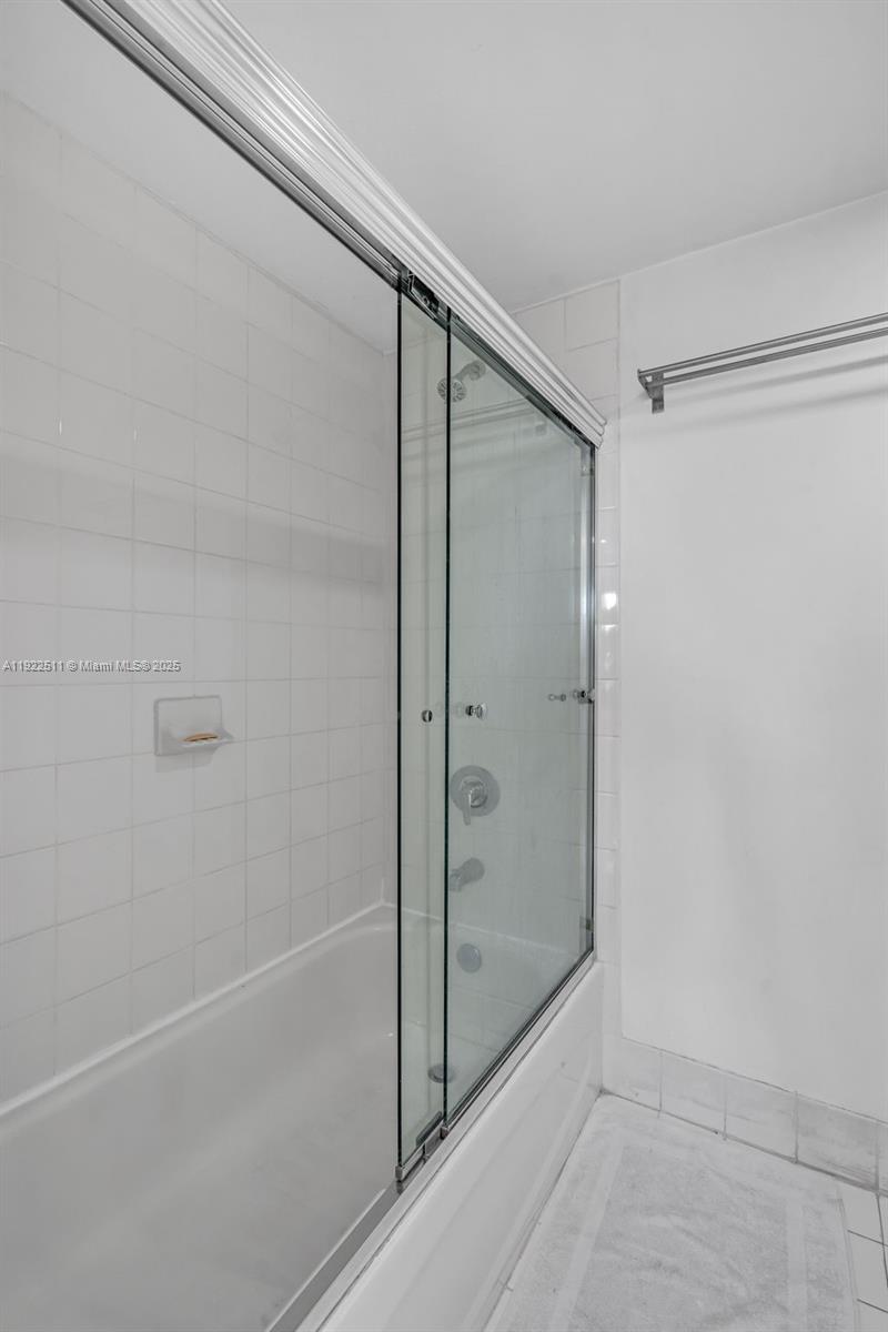 816 Northwest 11th Street, Unit 607 Miami, FL 33136 - Photo 4 of 38 a bathroom with a glass shower door