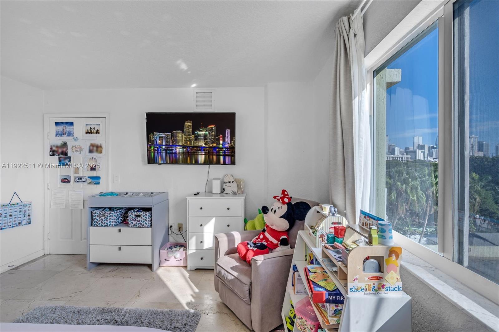 816 Northwest 11th Street, Unit 607 Miami, FL 33136 - Photo 7 of 38 a living room with furniture and a baby crib
