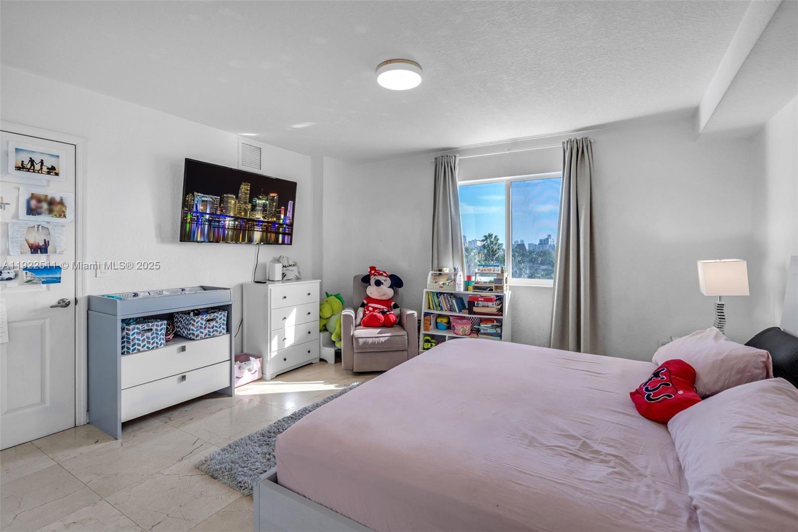 816 Northwest 11th Street, Unit 607 Miami, FL 33136 - Photo 8 of 38 a bedroom with a bed and a flat screen tv