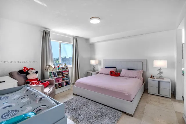 a bedroom with a bed and large windows