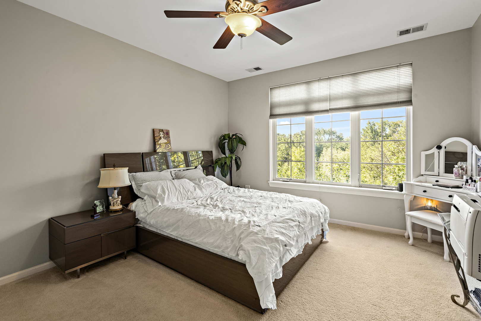 660 McHenry Road, Unit 306 Wheeling, IL 60090 - Photo 11 of 17 a bed room with a bed and a chandelier
