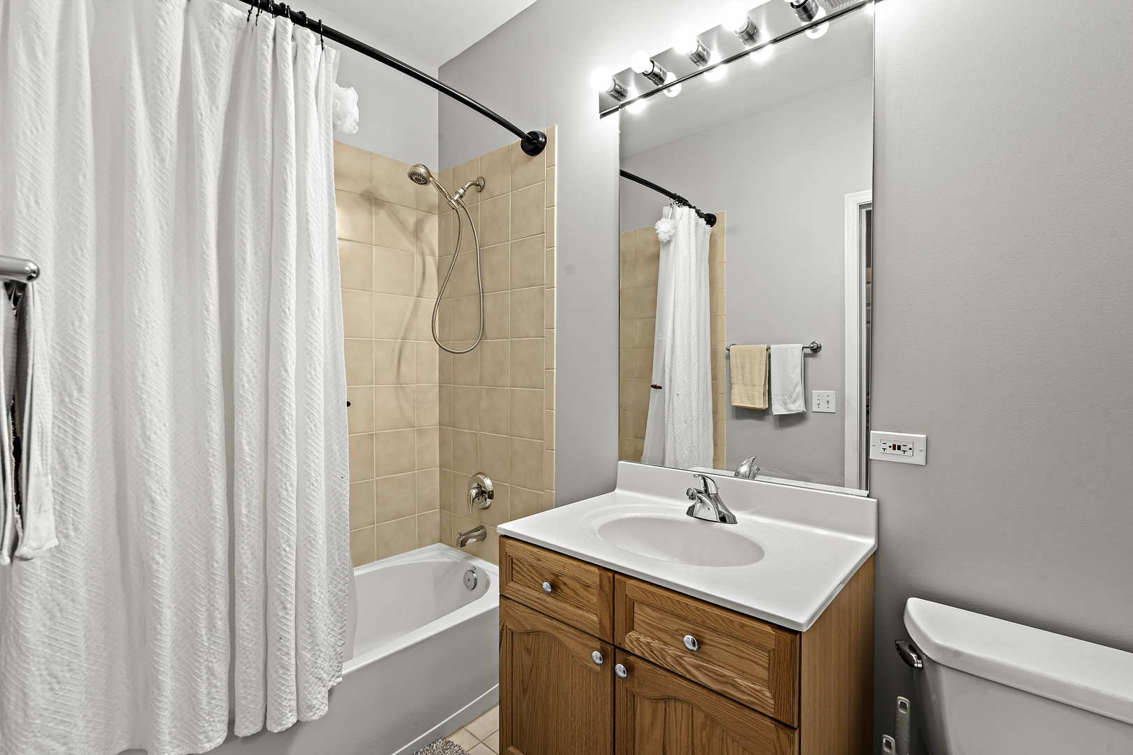660 McHenry Road, Unit 306 Wheeling, IL 60090 - Photo 14 of 17 a bathroom with a sink a toilet and shower