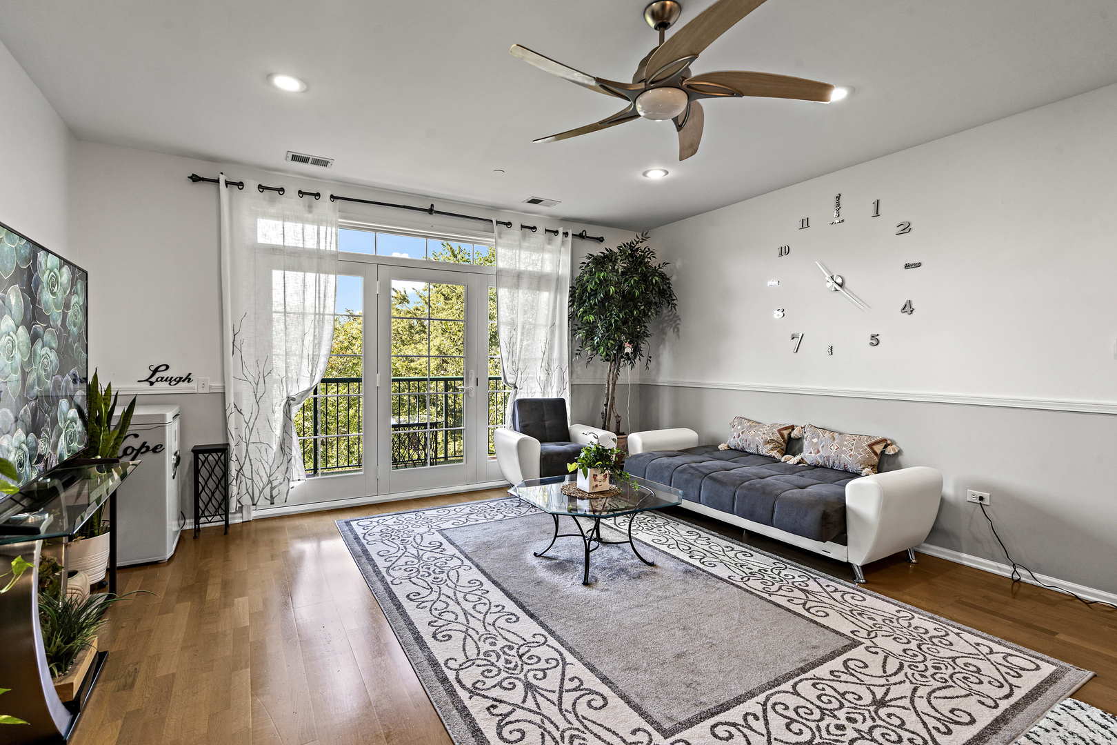 660 McHenry Road, Unit 306 Wheeling, IL 60090 - Photo 3 of 17 a living room with furniture and a large window