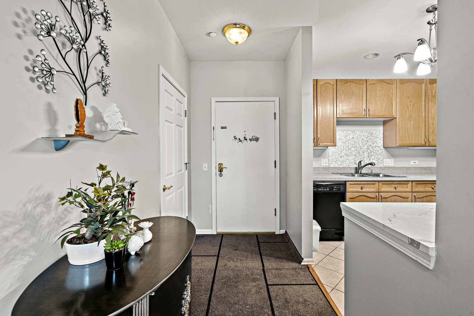 660 McHenry Road, Unit 306 Wheeling, IL 60090 - Photo 6 of 17 a kitchen with a sink and a refrigerator