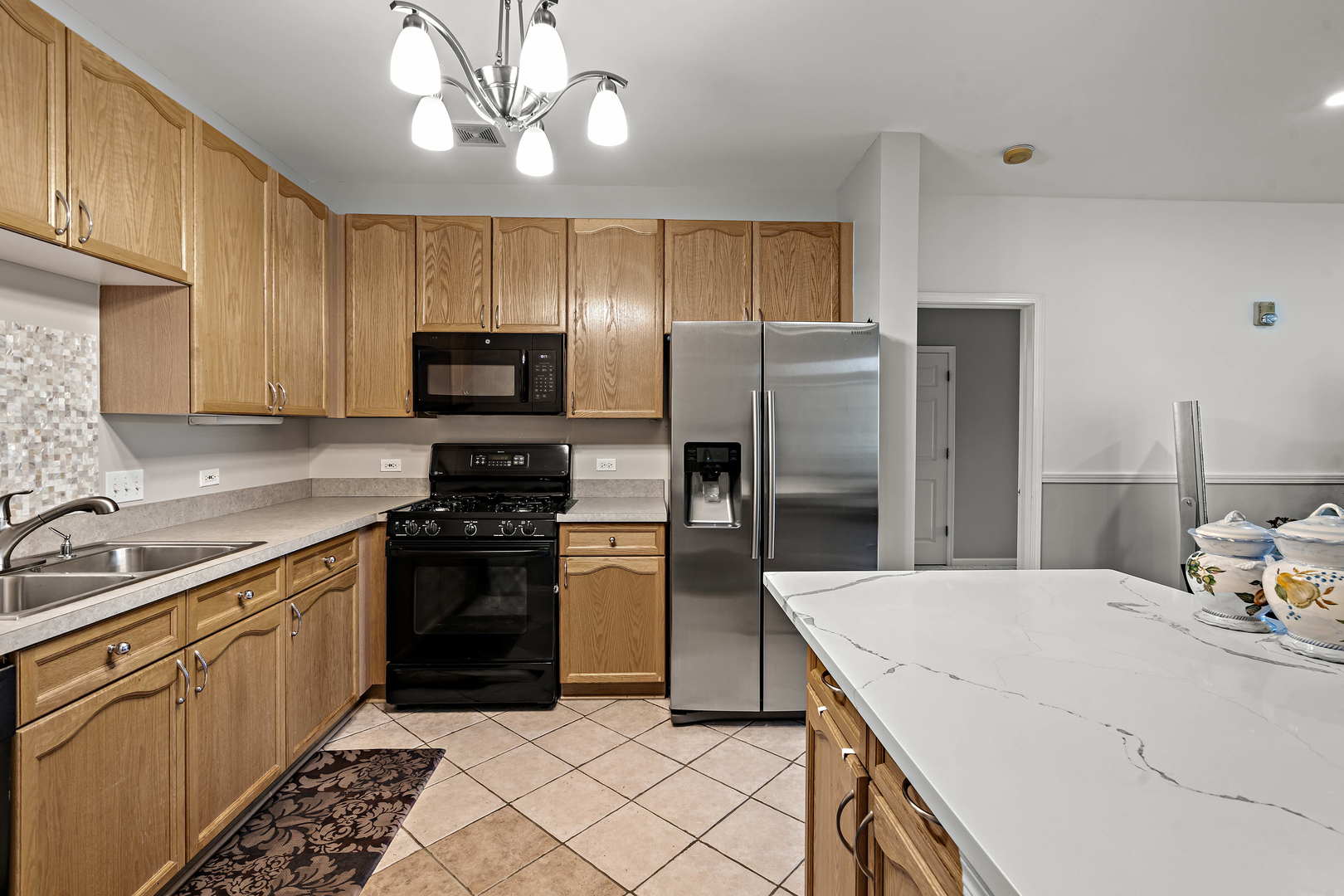660 McHenry Road, Unit 306 Wheeling, IL 60090 - Photo 7 of 17 a kitchen with a refrigerator a sink and a stove