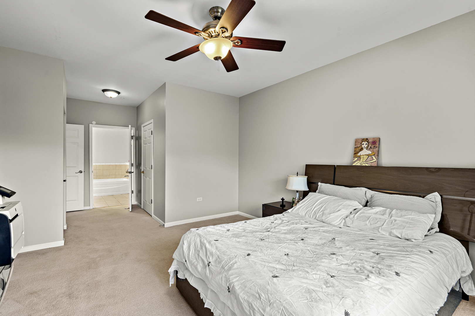 660 McHenry Road, Unit 306 Wheeling, IL 60090 - Photo 9 of 17 a bedroom with a large bed and a chandelier
