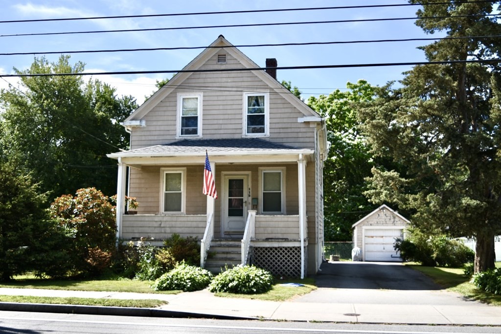 113 Howland Road Fairhaven, MA 02719 - Photo 1 of 13 a front view of a house with a yard and garage