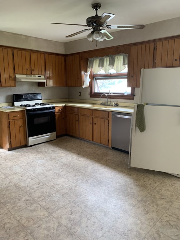 113 Howland Road Fairhaven, MA 02719 - Photo 6 of 13 a kitchen with stainless steel appliances granite countertop a stove a sink dishwasher and a refrigerator