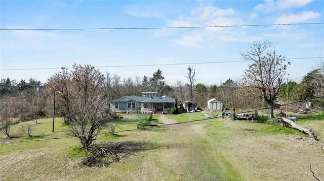 a view of a house with a yard and sitting area