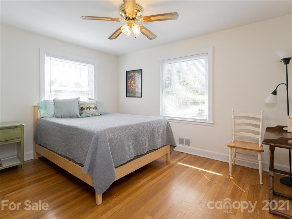 298 Erwin Hills Road Asheville, NC 28806 - Photo 11 of 48 a bedroom with a bed and a desk