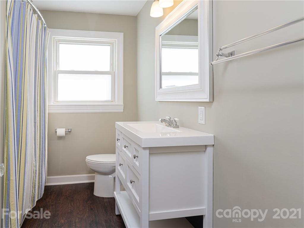 298 Erwin Hills Road Asheville, NC 28806 - Photo 12 of 48 a bathroom with a sink a toilet and a window