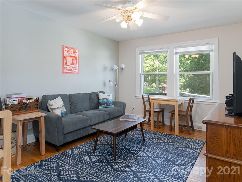 298 Erwin Hills Road Asheville, NC 28806 - Photo 13 of 48 a living room with furniture a table and a large window