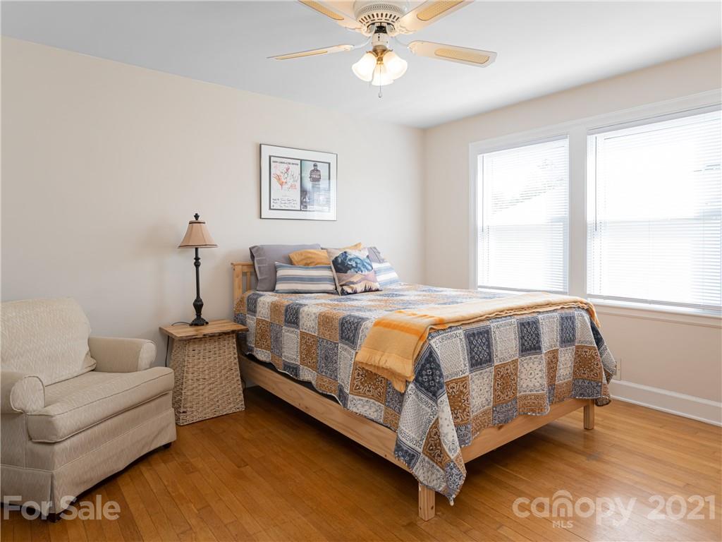 298 Erwin Hills Road Asheville, NC 28806 - Photo 14 of 48 a spacious bedroom with a bed and a couch