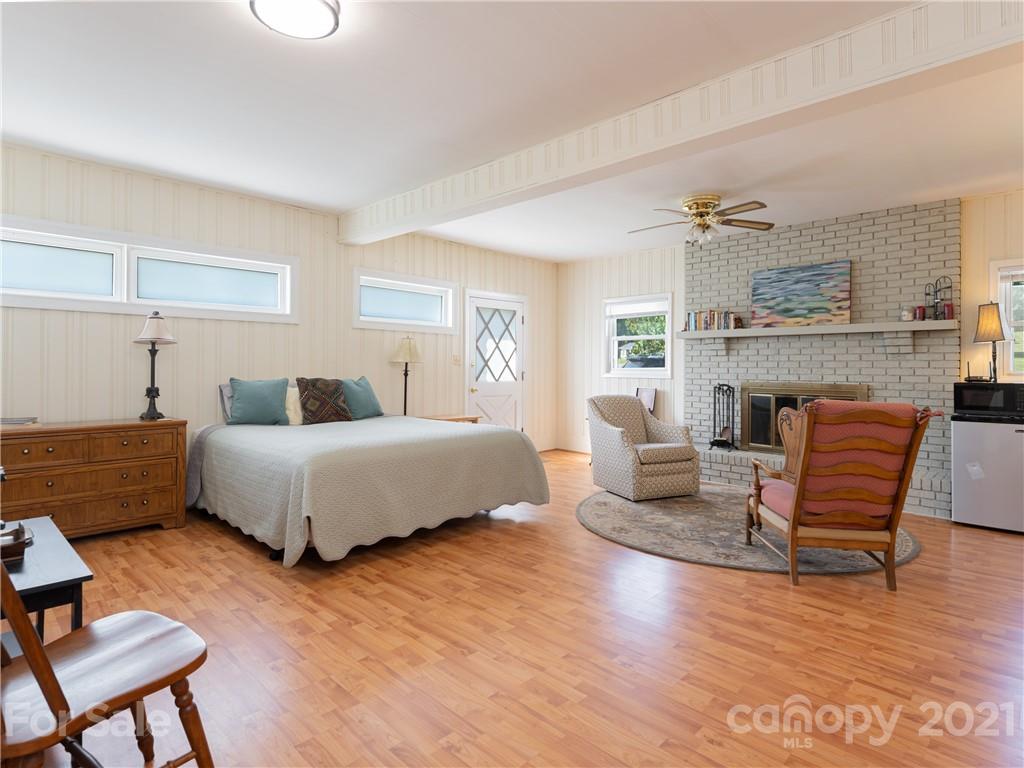 298 Erwin Hills Road Asheville, NC 28806 - Photo 15 of 48 a bedroom with furniture and a wooden floor