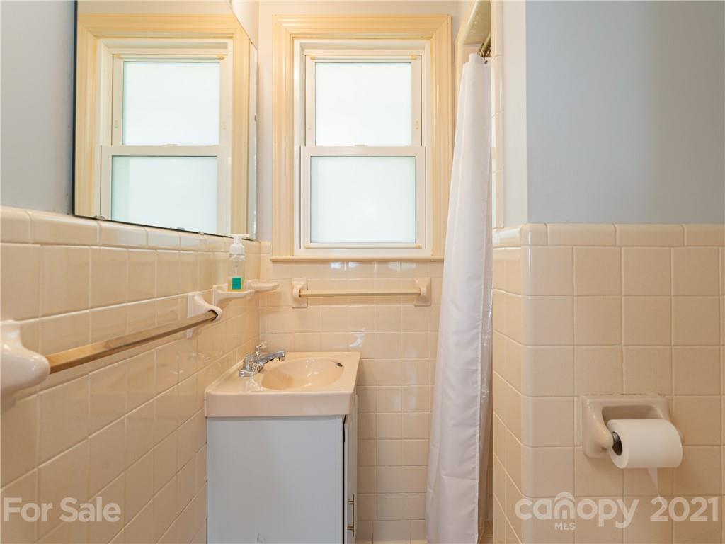 298 Erwin Hills Road Asheville, NC 28806 - Photo 20 of 48 a bathroom with a sink and a window