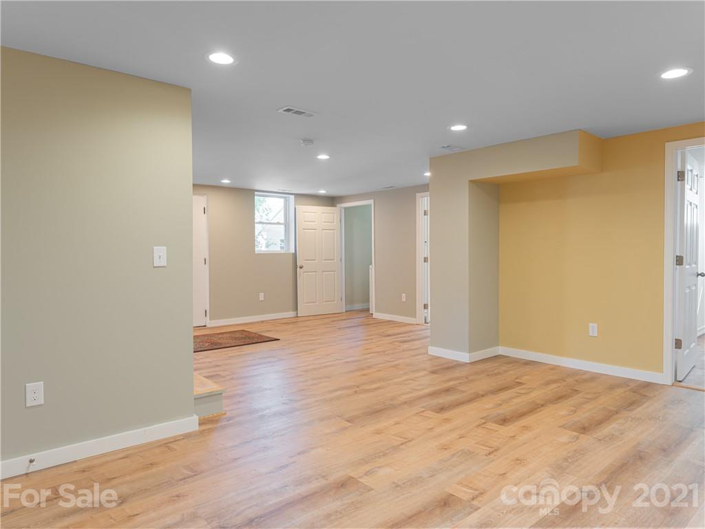 298 Erwin Hills Road Asheville, NC 28806 - Photo 26 of 48 a view of an empty room with wooden floor