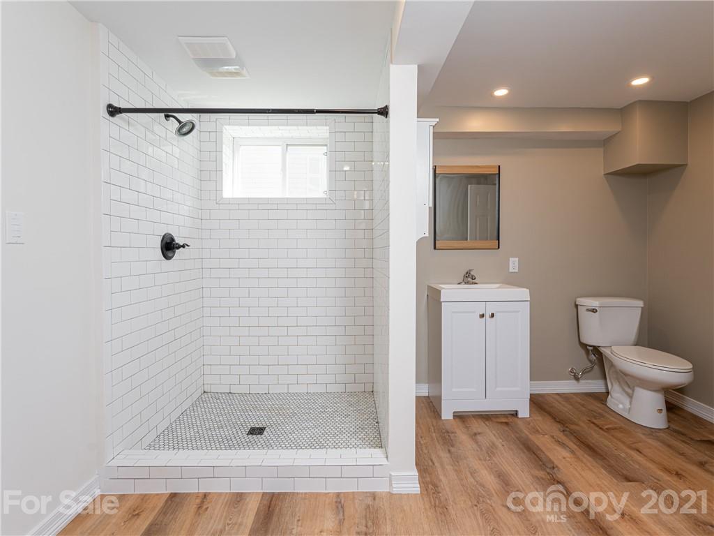 298 Erwin Hills Road Asheville, NC 28806 - Photo 30 of 48 a bathroom with a shower a toilet and a sink