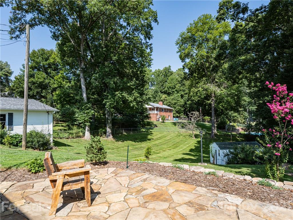 298 Erwin Hills Road Asheville, NC 28806 - Photo 33 of 48 a view of a chair and table in the garden