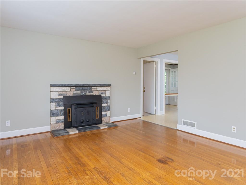 298 Erwin Hills Road Asheville, NC 28806 - Photo 5 of 48 a view of empty room with a fireplace