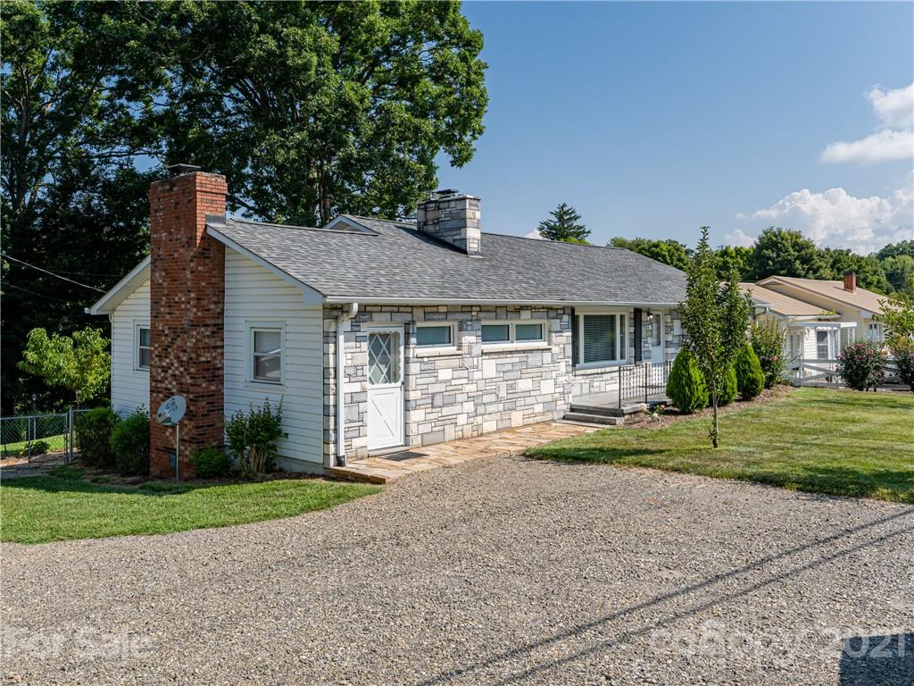 298 Erwin Hills Road Asheville, NC 28806 - Photo 47 of 48 a front view of a house with a yard and potted plants