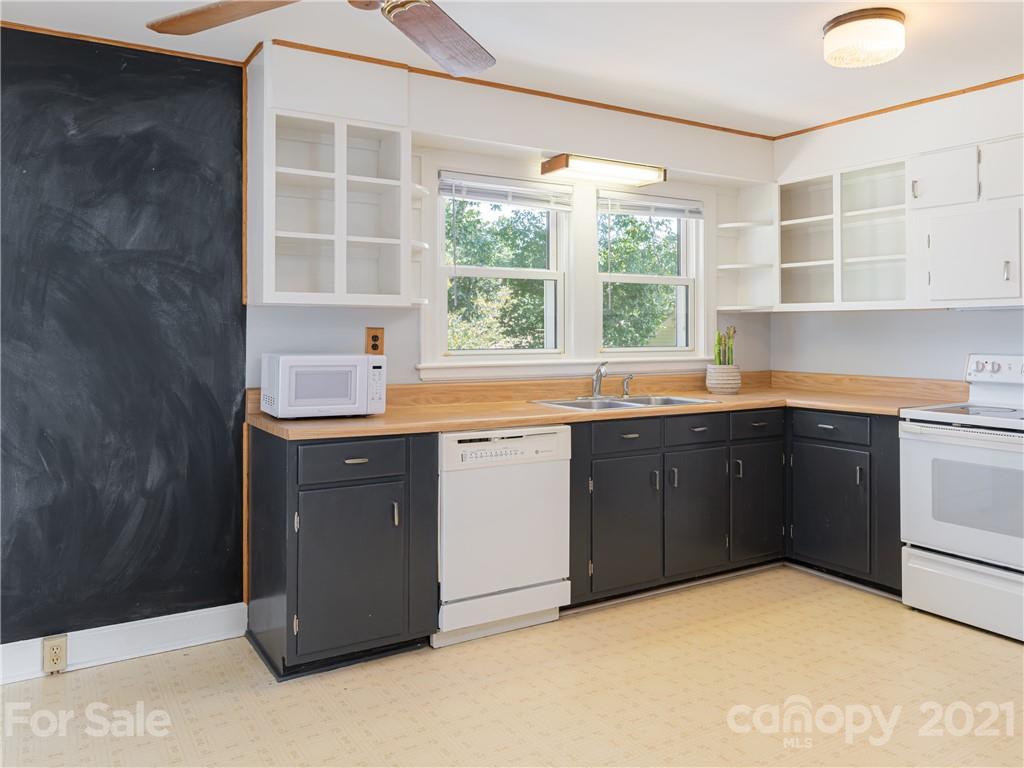 298 Erwin Hills Road Asheville, NC 28806 - Photo 7 of 48 a kitchen with a sink window and cabinets