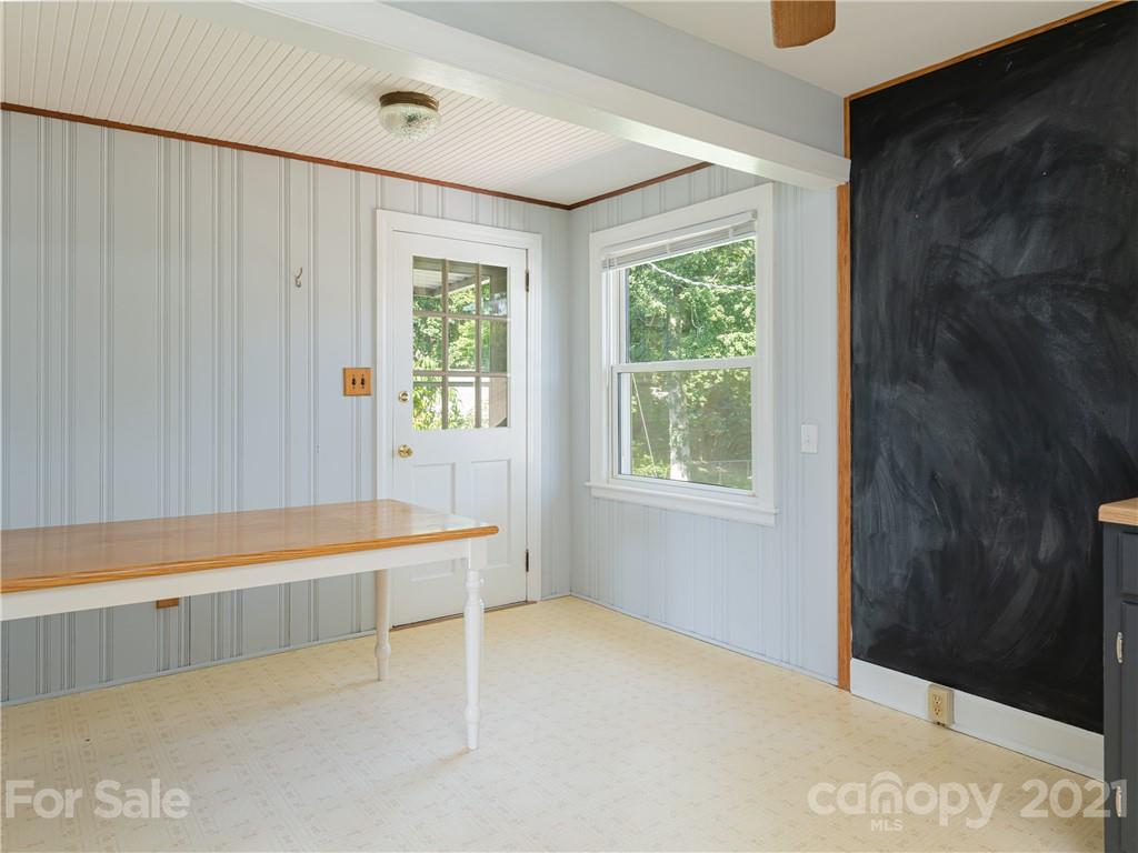 298 Erwin Hills Road Asheville, NC 28806 - Photo 8 of 48 a view of an empty room with a window