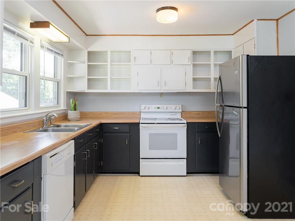 298 Erwin Hills Road Asheville, NC 28806 - Photo 9 of 48 a kitchen with a sink stove and refrigerator
