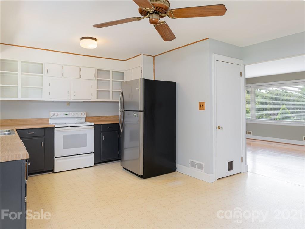 298 Erwin Hills Road Asheville, NC 28806 - Photo 10 of 48 a kitchen with a refrigerator and a sink